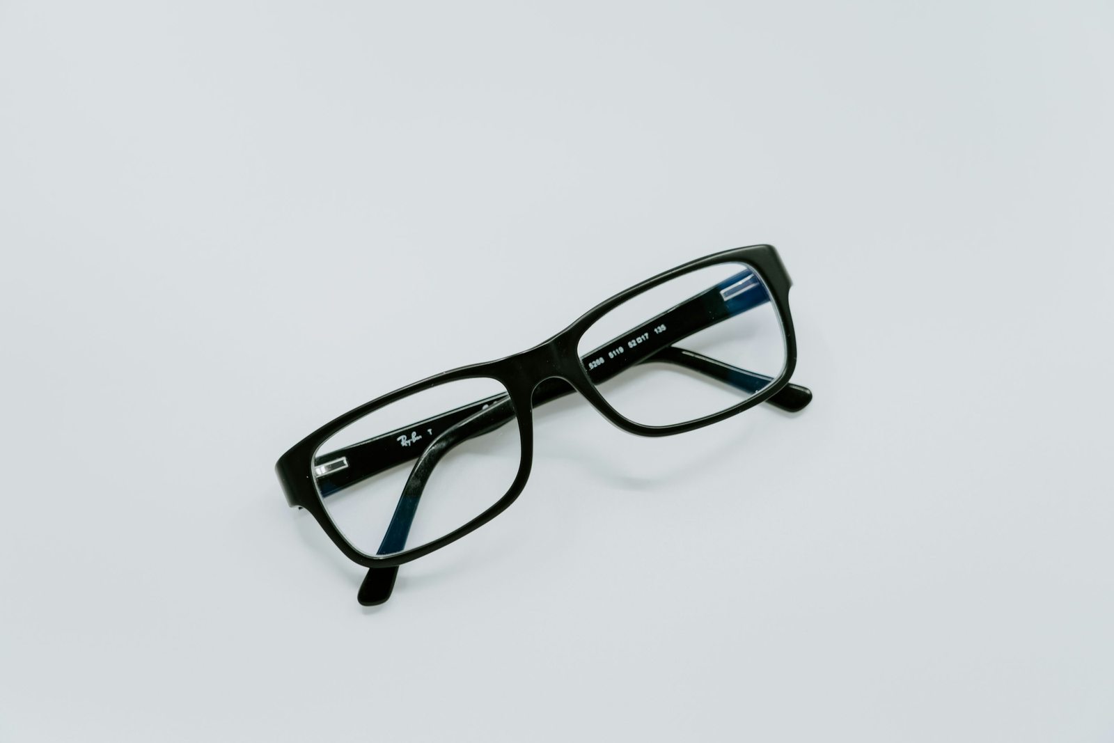 Illustrative optical frames photographed on a pale background
